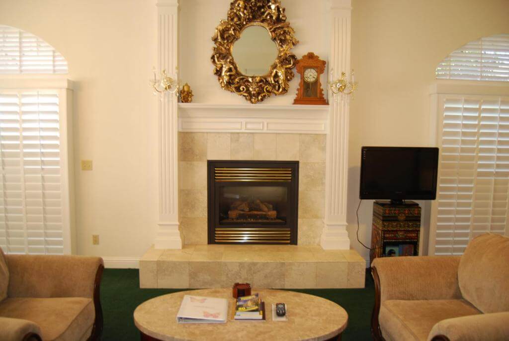 shared living area with television and ornate fireplace