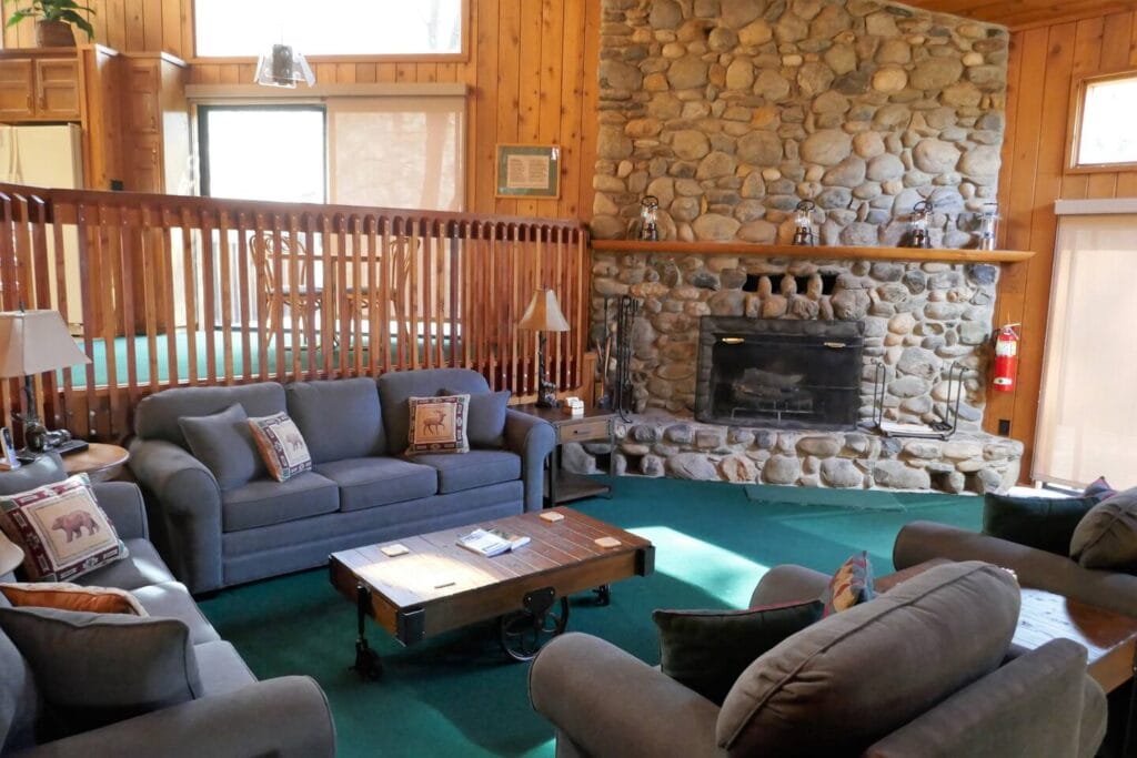 living room with stone fireplace