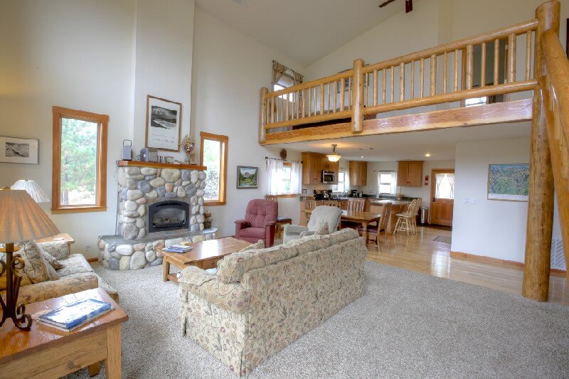 large living room with loft and fireplace