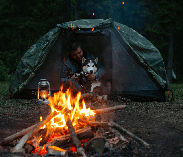 tent with fire, man and dog