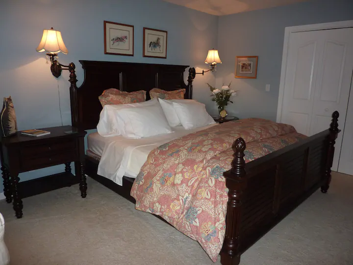 bedroom with queen bed and wood bed frame