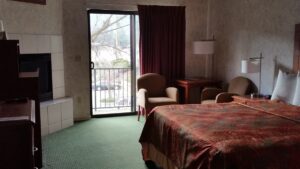 bedroom with balcony and seating area