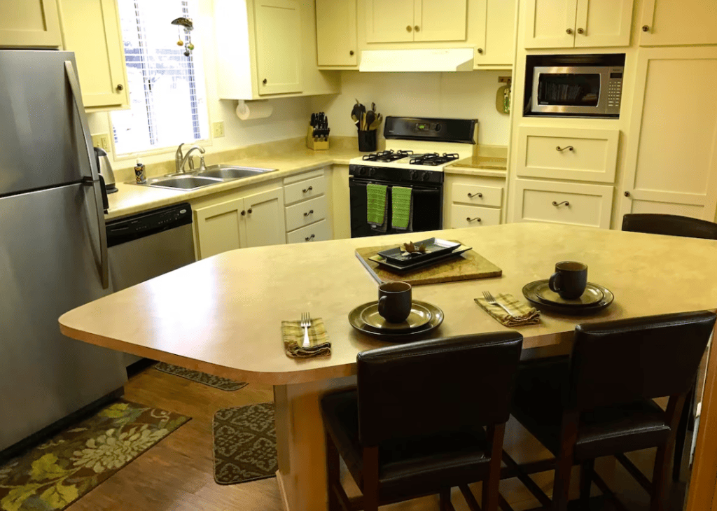 kitchen with white cabinets and island seating