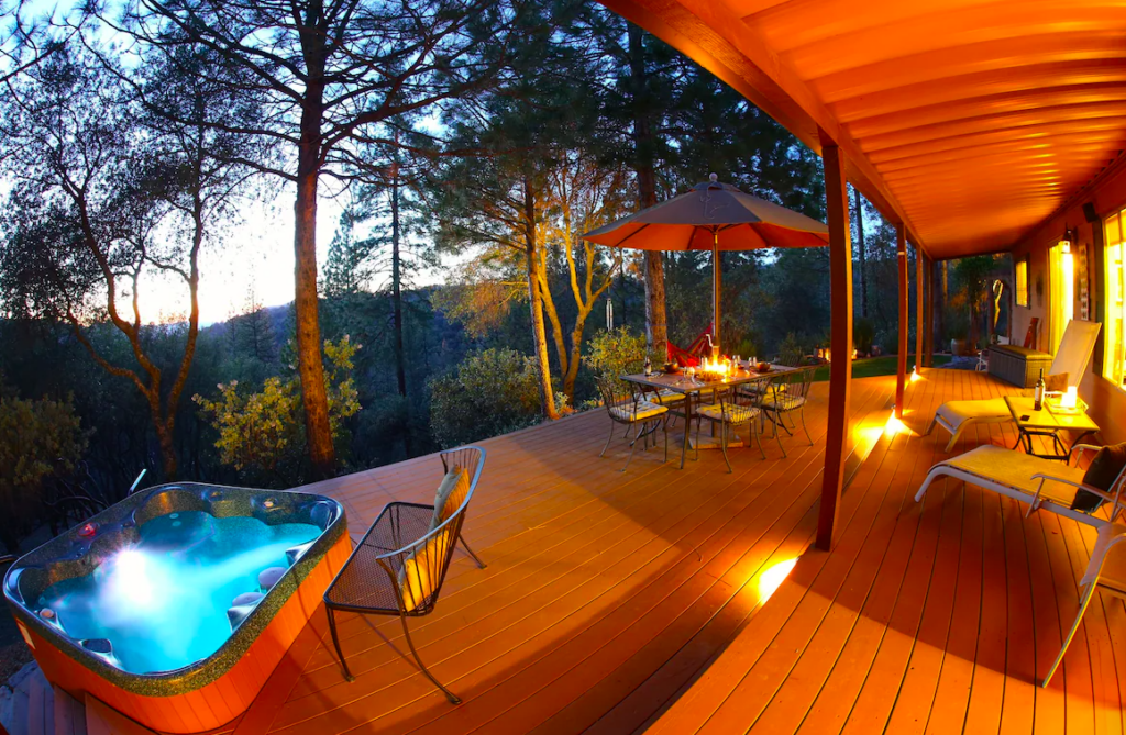 deck with outdoor seating and hot tub