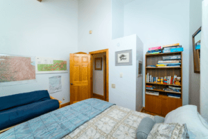 bedroom with queen bed and futon