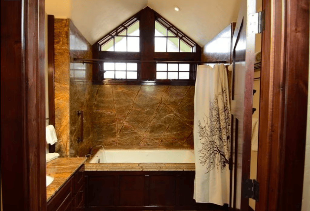 bathroom with craftsman details and spa tub