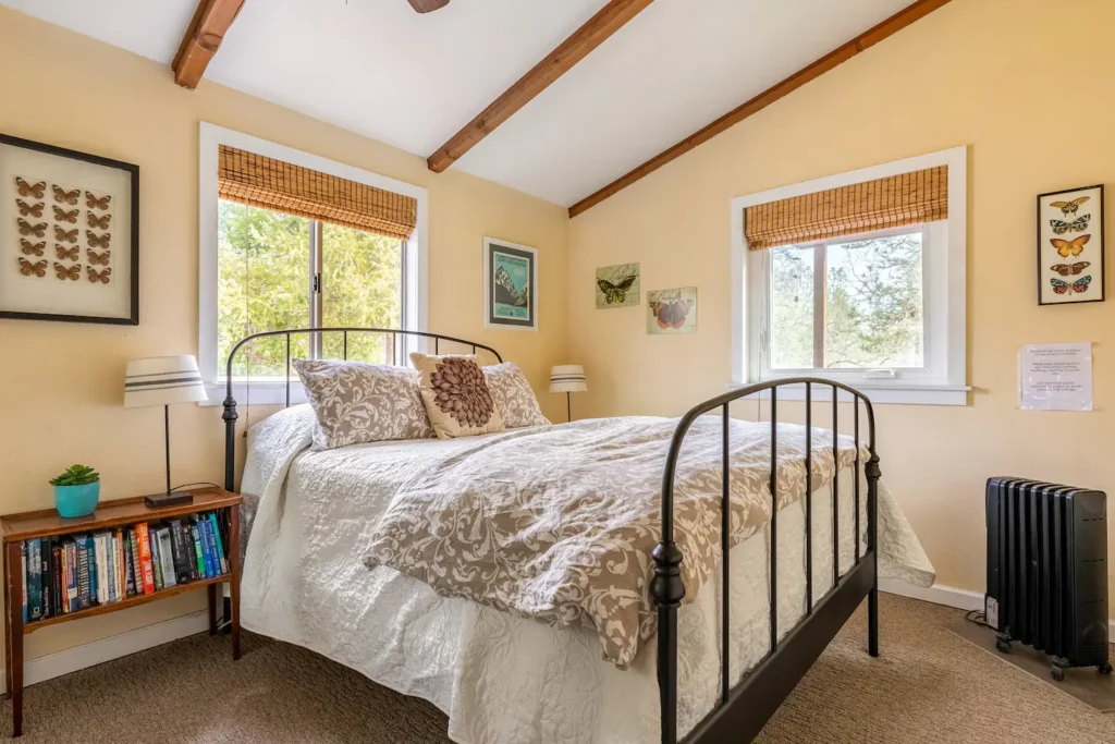 second bedroom with queen bed and tall ceilings