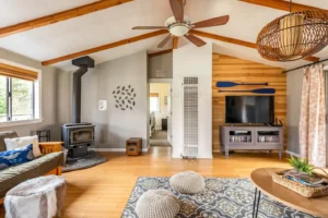 living room with wood stove and tall ceilings