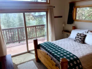 bedroom with queen size bed and balcony access