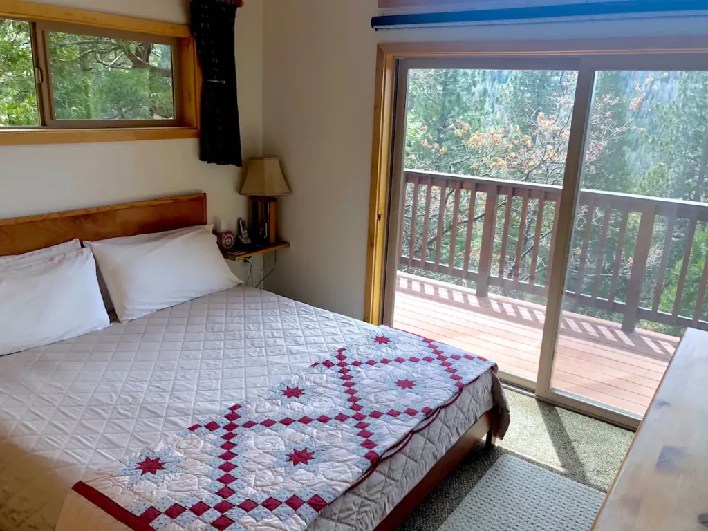 bedroom with queen size bed and balcony access