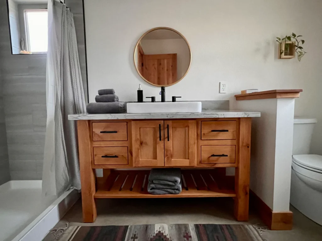 bathroom with walk in shower and vanity