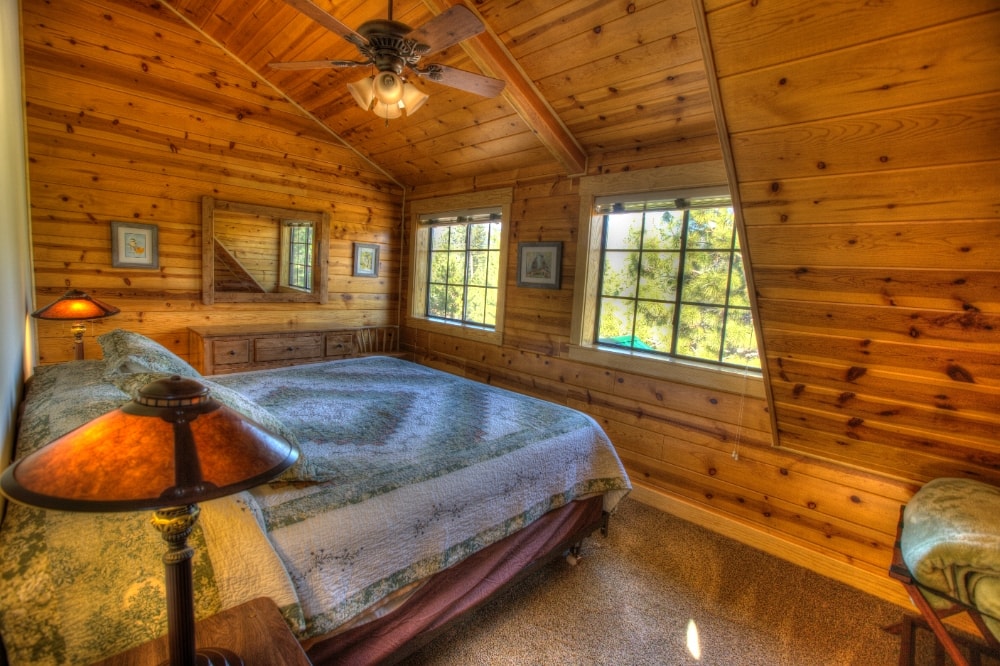 bedroom with wood paneled walls