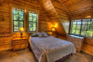 primary bedroom with wood paneled walls