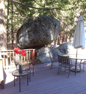 deck with outdoor seating built into large boulders