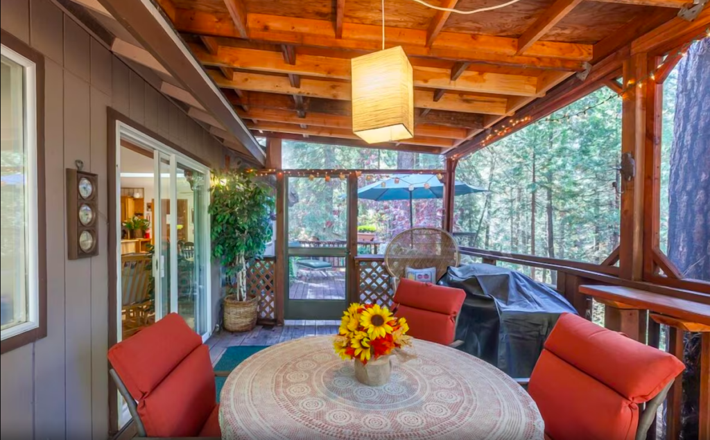 screened in porch with grill and dining