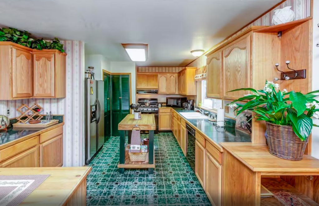 kitchen with green tile floor and wood cabinets with island