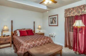 bedroom with queen bed and red accents