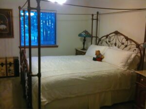 bedroom with queen bed and iron bedframe