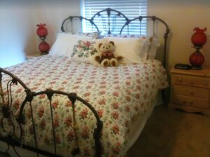 bedroom with queen bed and iron bed frame