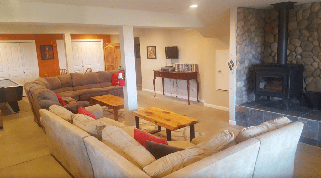 living area with couches , wood stove, television