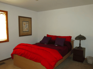 bedroom with queen bed and red bedding