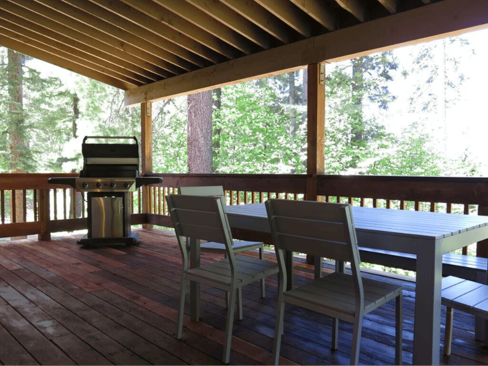 covered deck with grill and outdoor seating