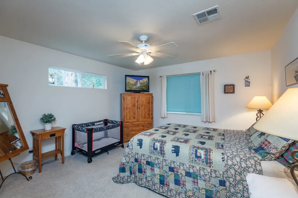 primary bedroom with television and king bed