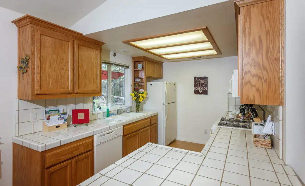 kitchen with white countertops and wood cabinets