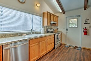 kitchen with wood beams, floors and cabinets