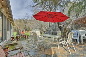 patio with outdoor seating and red umbrella
