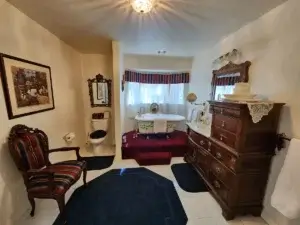 bathroom with elevated claw foot tub and antique decorations