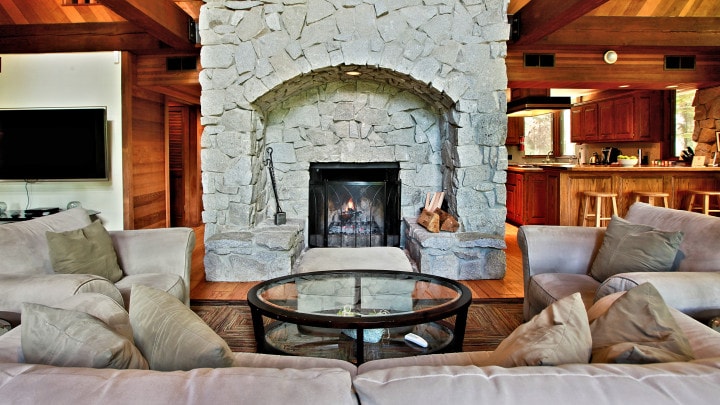 living area with large stone fireplace and couches