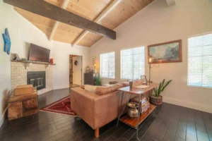 couch and view of fireplace with television