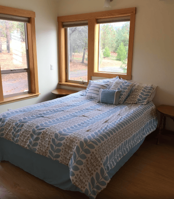 bedroom with queen bed and windows