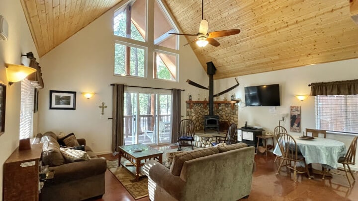 living room with vaulted ceilings and wood stove