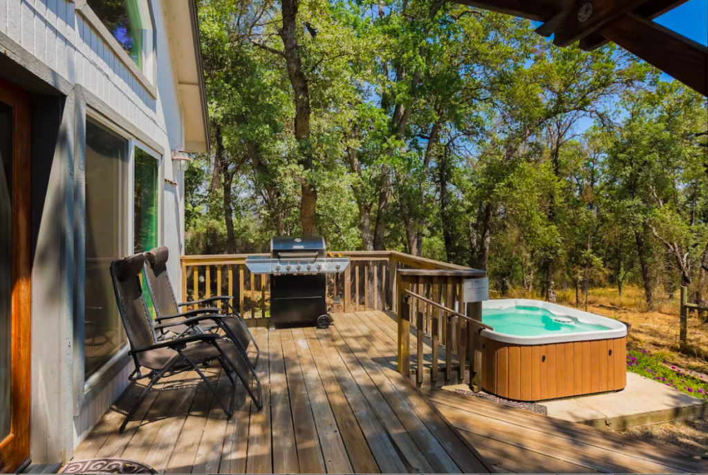 deck with outdoor seating and hot tub