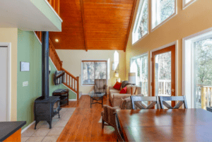 living and dining area with wood stove and seating