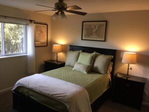 bedroom with queen bed and windows