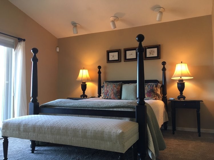 bedroom with four poster bed and slanted ceiling