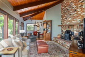 living room with stone fireplace and seating