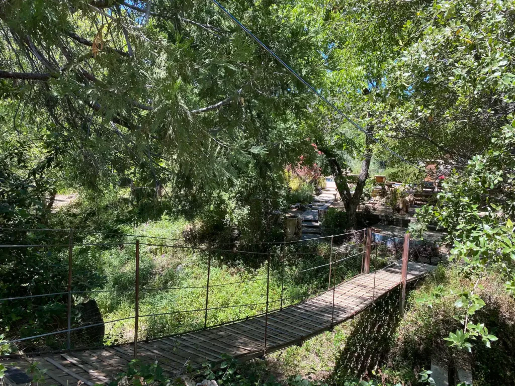 swing bridge from guest house to pool area