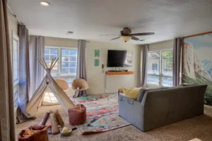 living room with couch, television, and kids play area