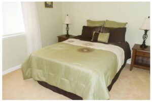bedroom with green and brown bedspread