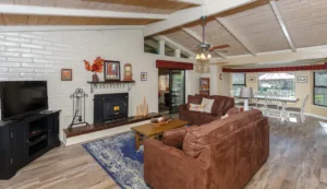 living room with fireplace and beams