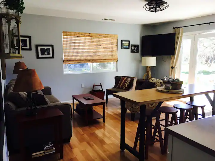 living room across from kitchen with television and couch