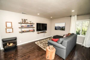 living area with television, couch, and fireplace