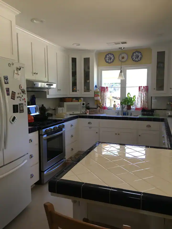 kitchen with tiles and white cabinets