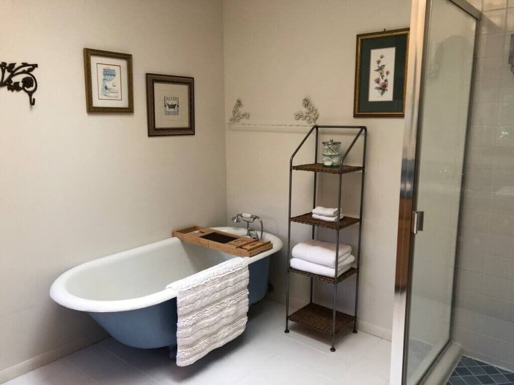 bathroom with clawfoot tub and full shower