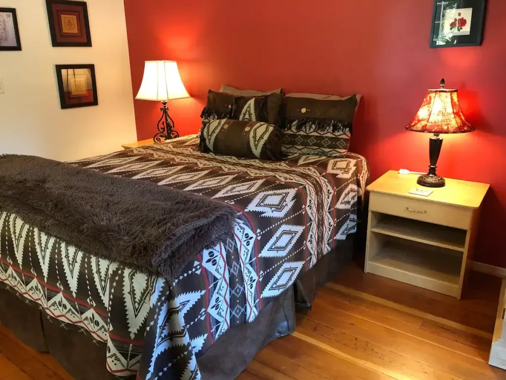 bedroom with red wall and full bed