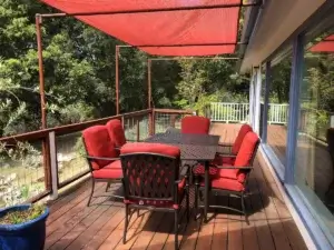 deck with sun shade and outdoor dining
